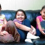 Pounds of toxic flame retardants are used on couches. Children are especially vulnerable. Alyssa Madsen (9 yrs), Brisais Madsen (3 yrs), Tasha Cox (3 yrs). Growing children are especially vulnerable to toxic chemicals. Photo by Samarys Seguinot-Medina