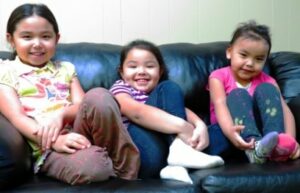 Pounds of toxic flame retardants are used on couches. Children are especially vulnerable. Alyssa Madsen (9 yrs), Brisais Madsen (3 yrs), Tasha Cox (3 yrs). Growing children are especially vulnerable to toxic chemicals. Photo by Samarys Seguinot-Medina